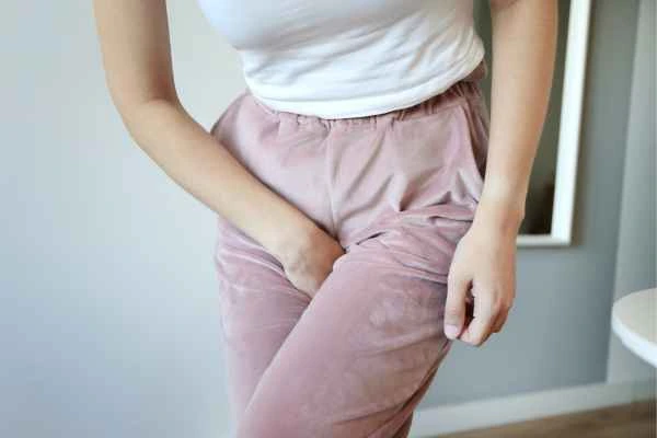 woman running for the toilet because of urinary incontinence Wales